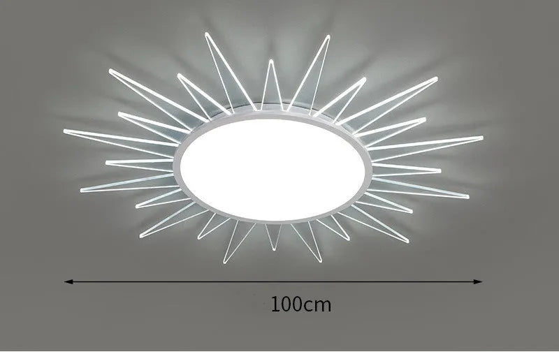 Modern round aluminium LED ceiling lamp with remote control on a white ceiling.