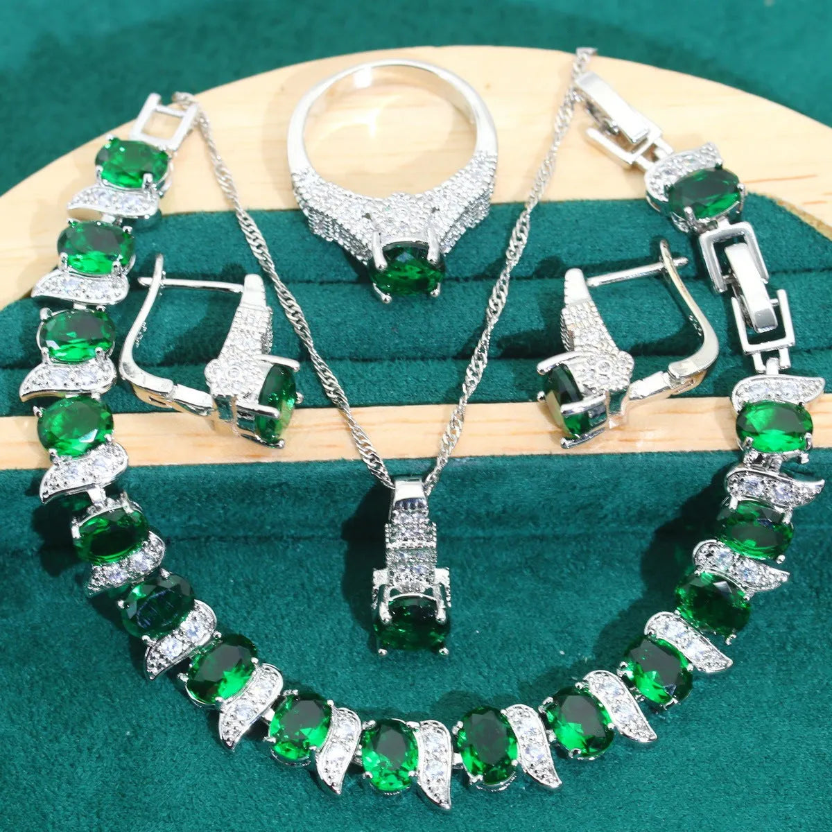 Four-piece bridal jewellery set showing zircon necklace, bracelet, earrings and ring with water wave chain design
