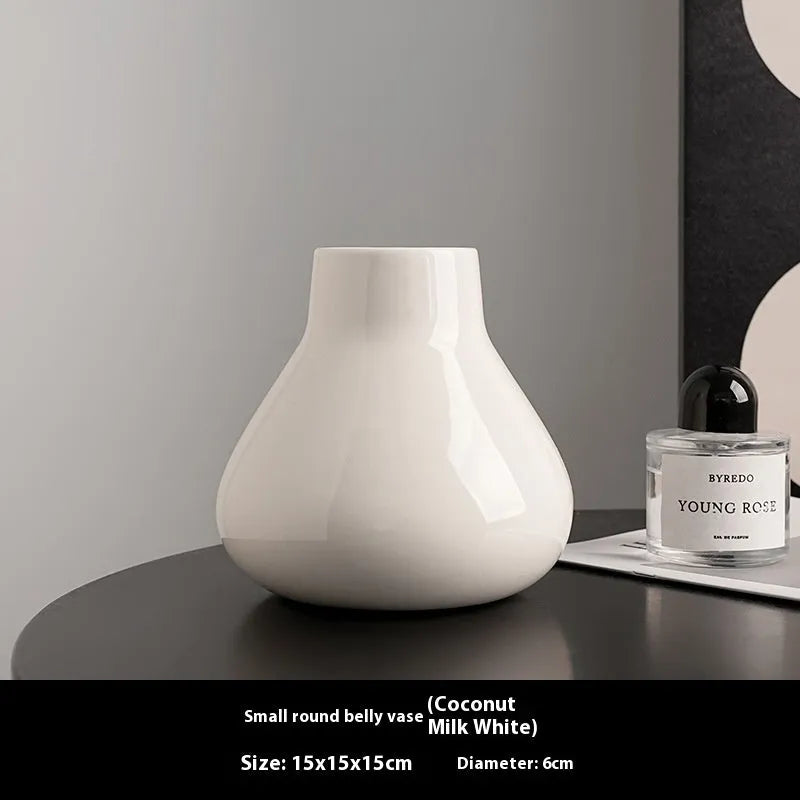 Ceramic decorative vase with coloured glaze surface and artificial orchid flowers in black or white colour