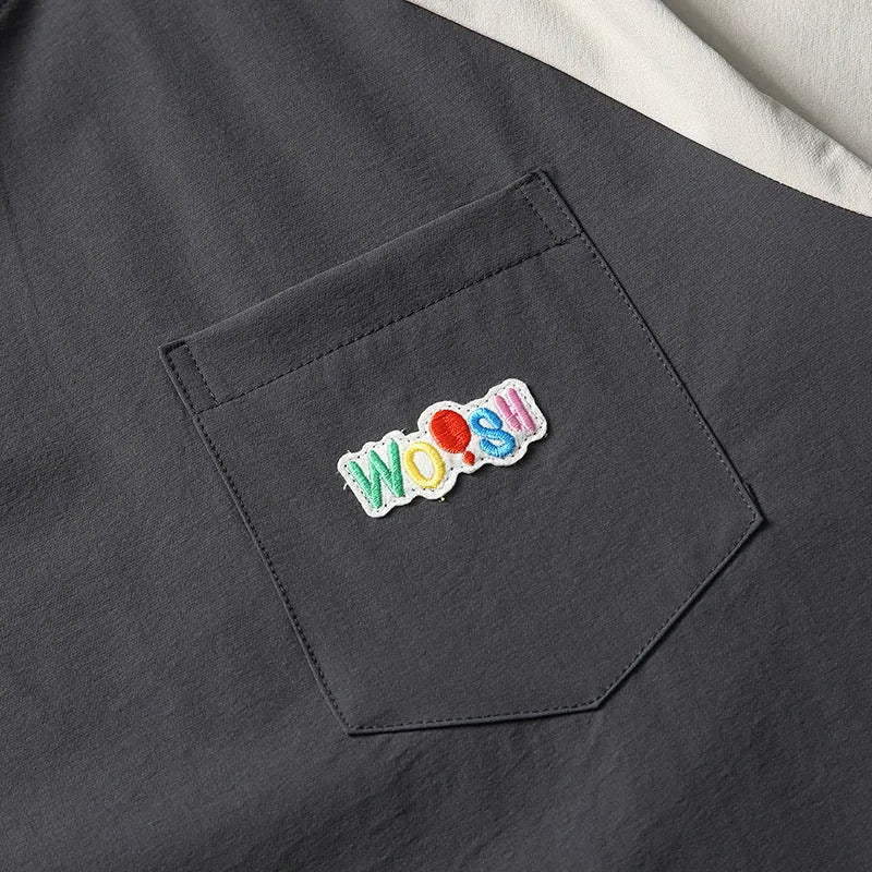 Dark grey loose fit t-shirt with contrast colour raglan short sleeves.