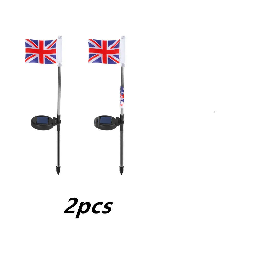 Solar-powered garden flag light displaying either American or British flag design with stainless steel pole and solar panel