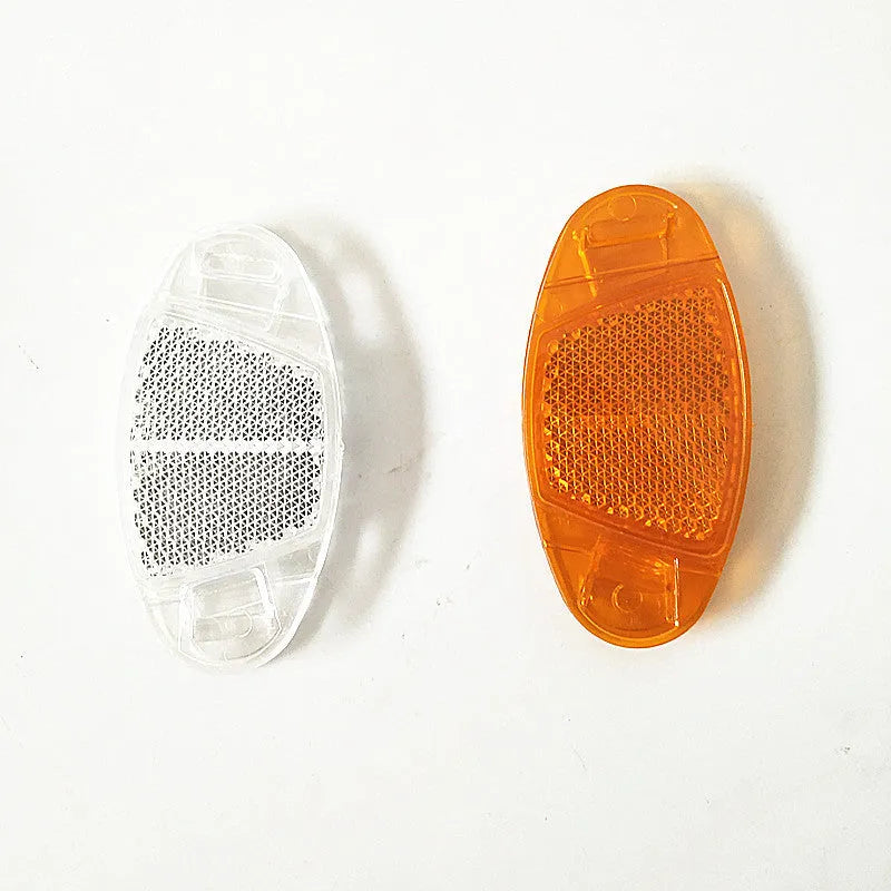 Bicycle spoke reflector showing yellow plastic construction with clip-on attachment for wheel safety
