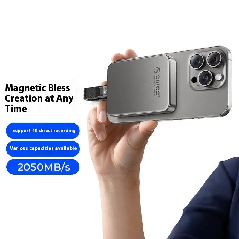 Grey magnetic mobile solid-state drive with suction ring, shown next to a USB-C cable.