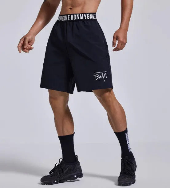 Men's loose-fit cropped sports shorts in black with elastic waist and letter details
