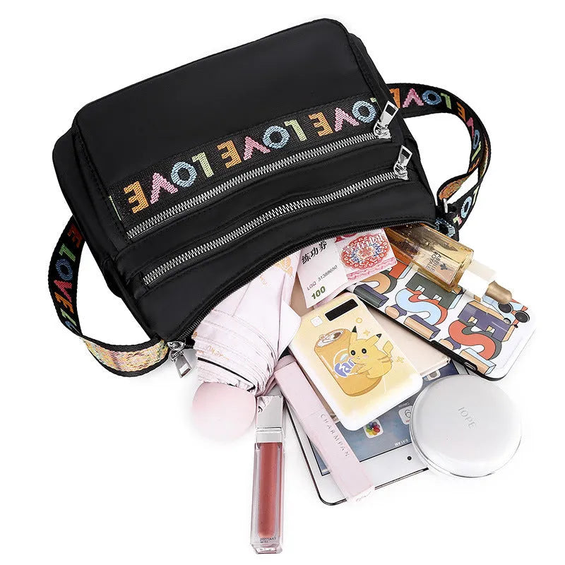 Soft oxford cloth crossbody shoulder bag with multiple pockets, letter stitching, available in black and red