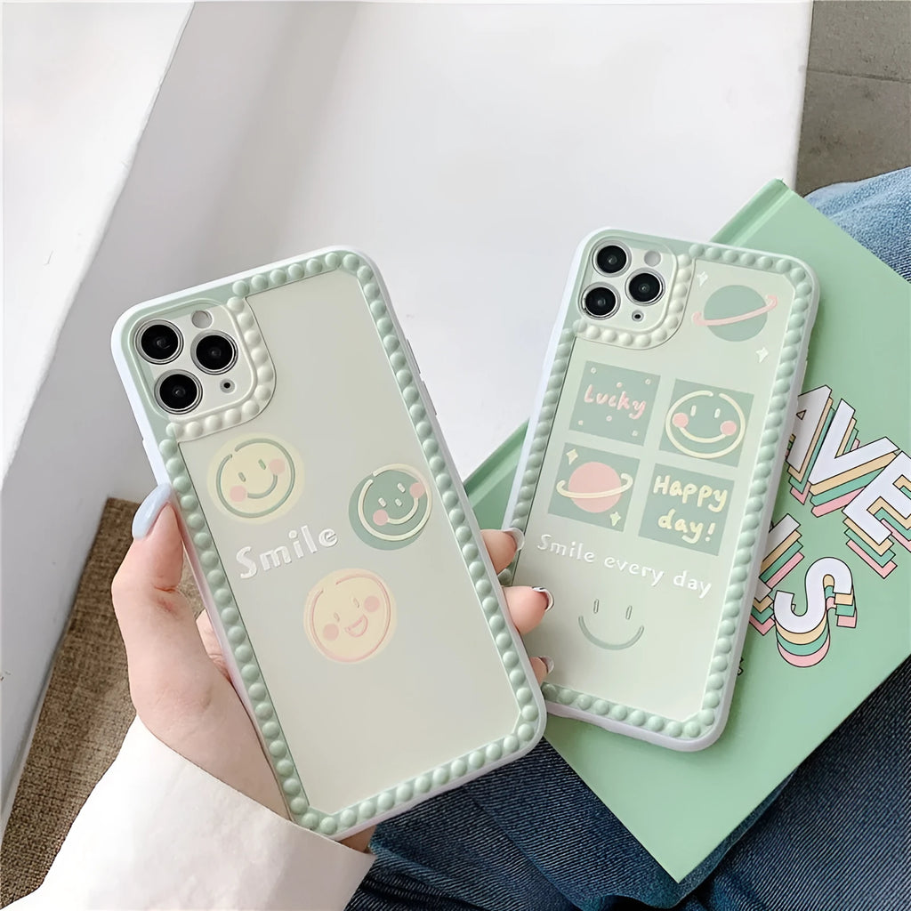 Green TPU phone case with geometric smiley face and polka dot frame design for iPhone.
