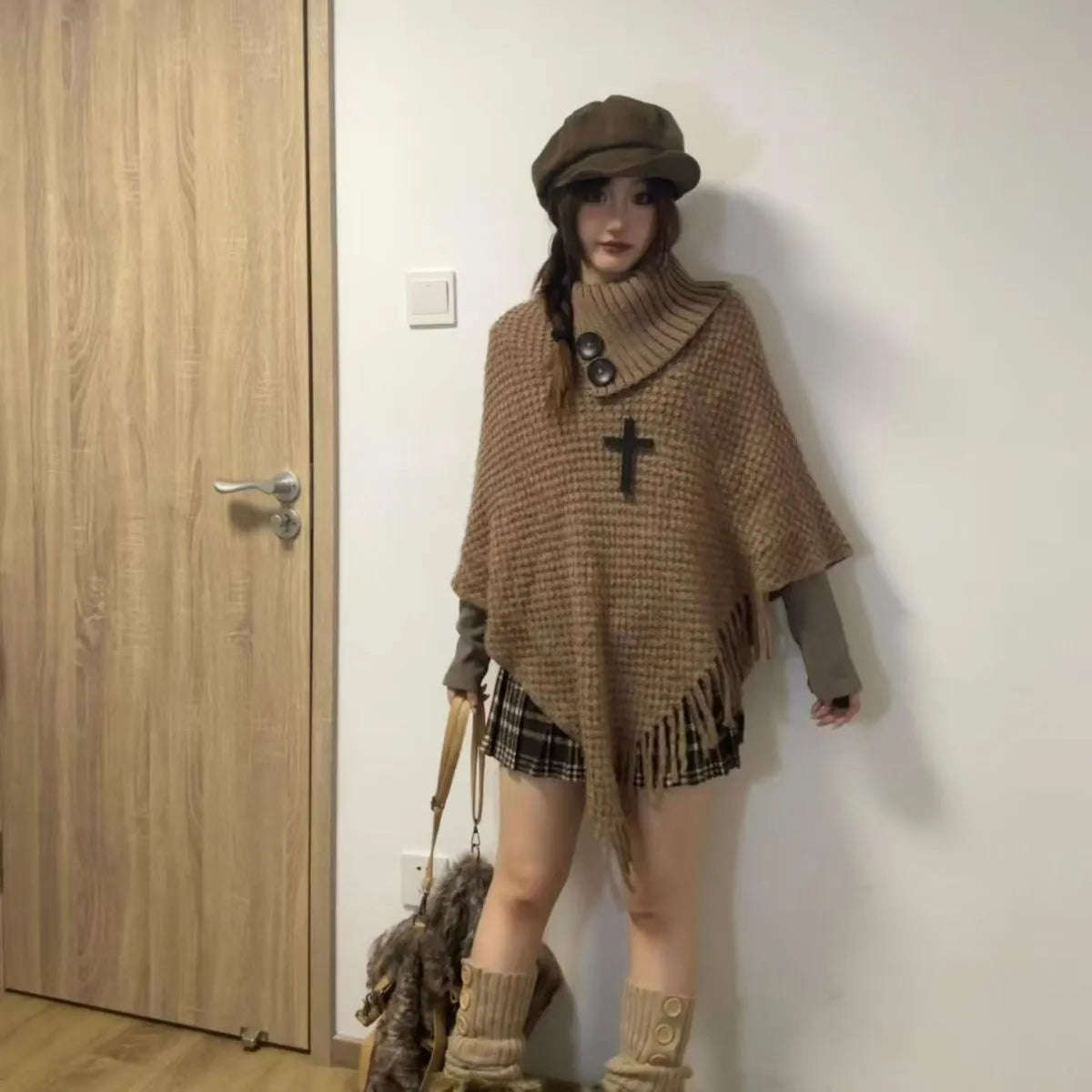 Women's triangular plush shawl cape in a cashmere blend with tassel detailing.