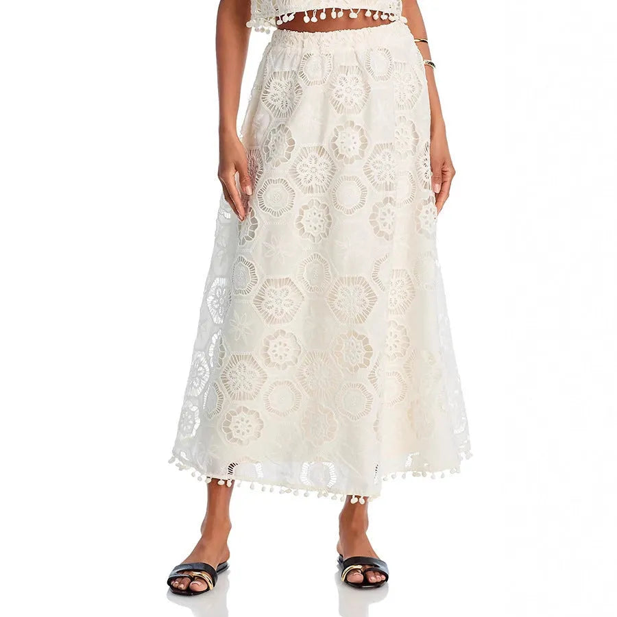White women's retro style suit with sleeveless top, embroidered long skirt on hanger