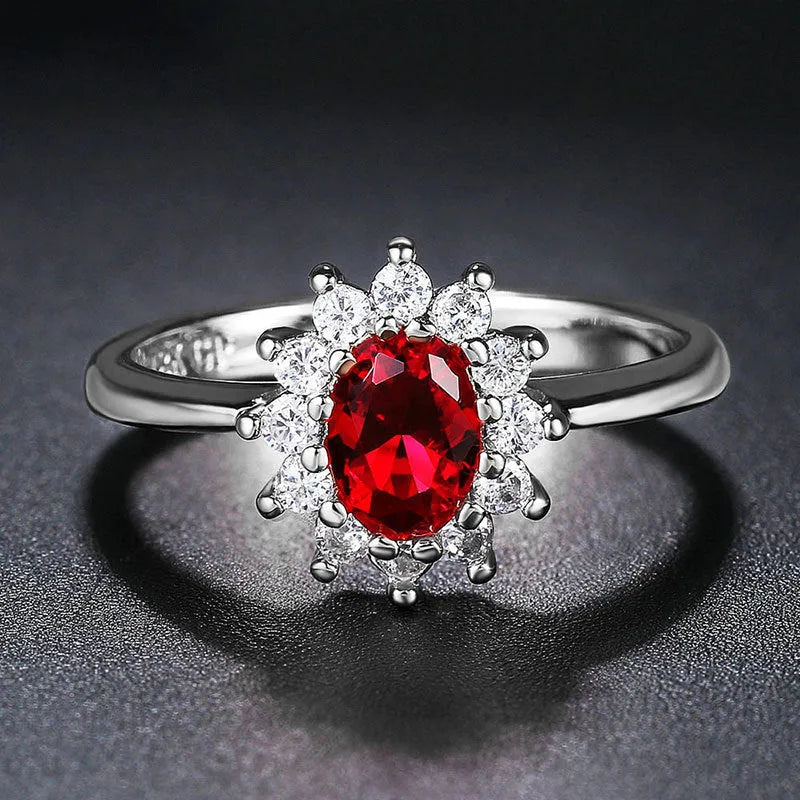 Women's blue moissanite and copper floral ring on a finger, showing zirconium inlay and electroplated colour.