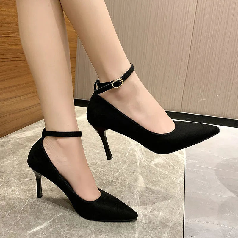 Women's black stiletto heel pumps with skull pattern and buckle closure