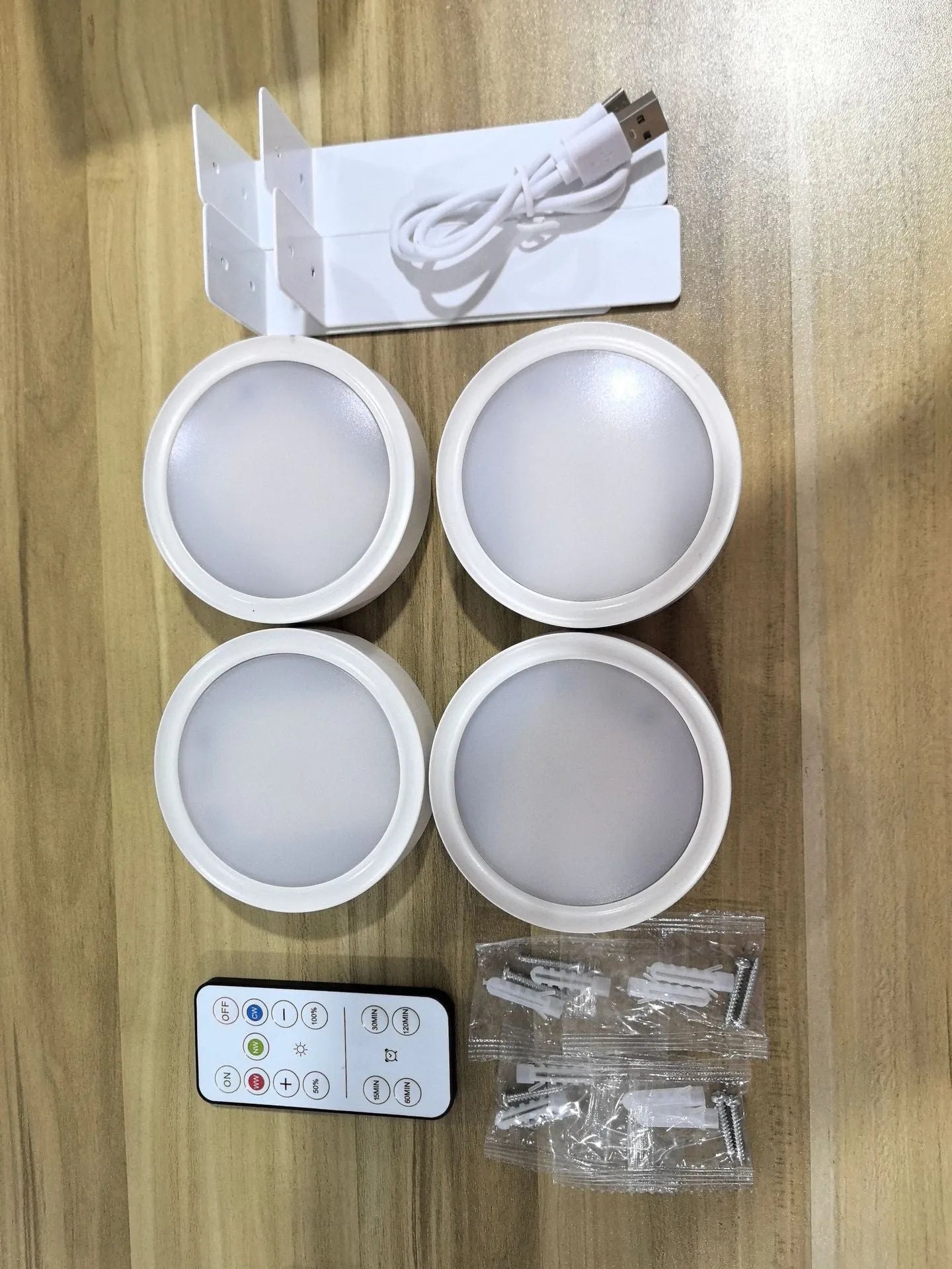Wireless rechargeable LED painting lamp with magnetic belt attached to a metal frame, remote control nearby.