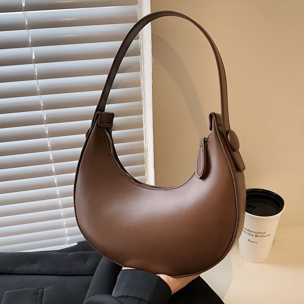 Women's retro dumpling shape shoulder bag in black with sandwich pocket and synthetic leather lining