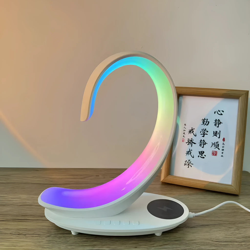 White swan-shaped desk lamp with colourful LED lights, Bluetooth speaker, and wireless charging pad.