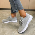Women's low-top mesh running shoes in creamy white with a rubber sole and round toe.
