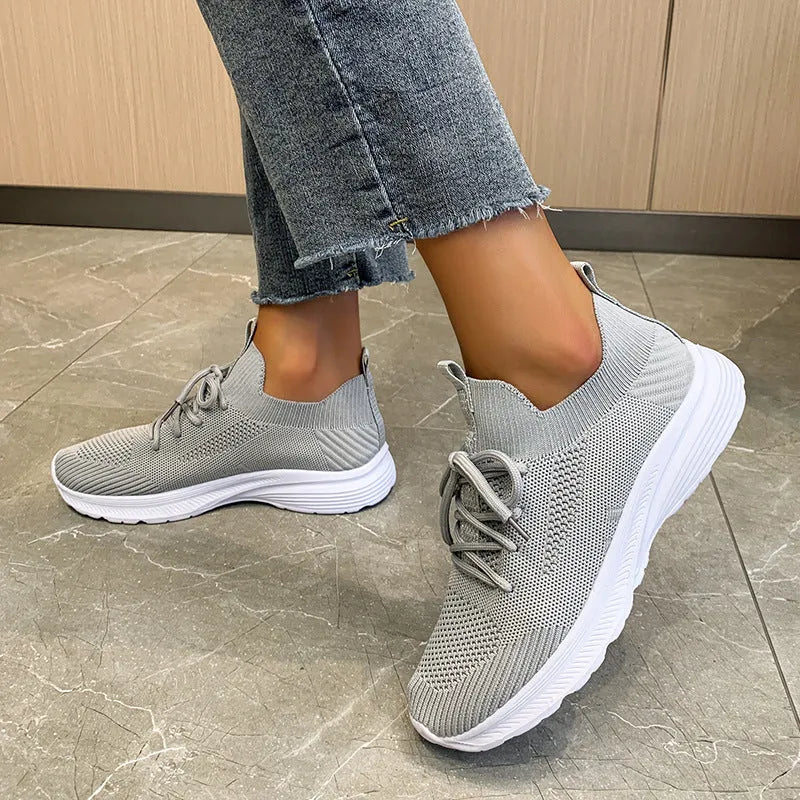 Women's low-top mesh running shoes in creamy white with a rubber sole and round toe.