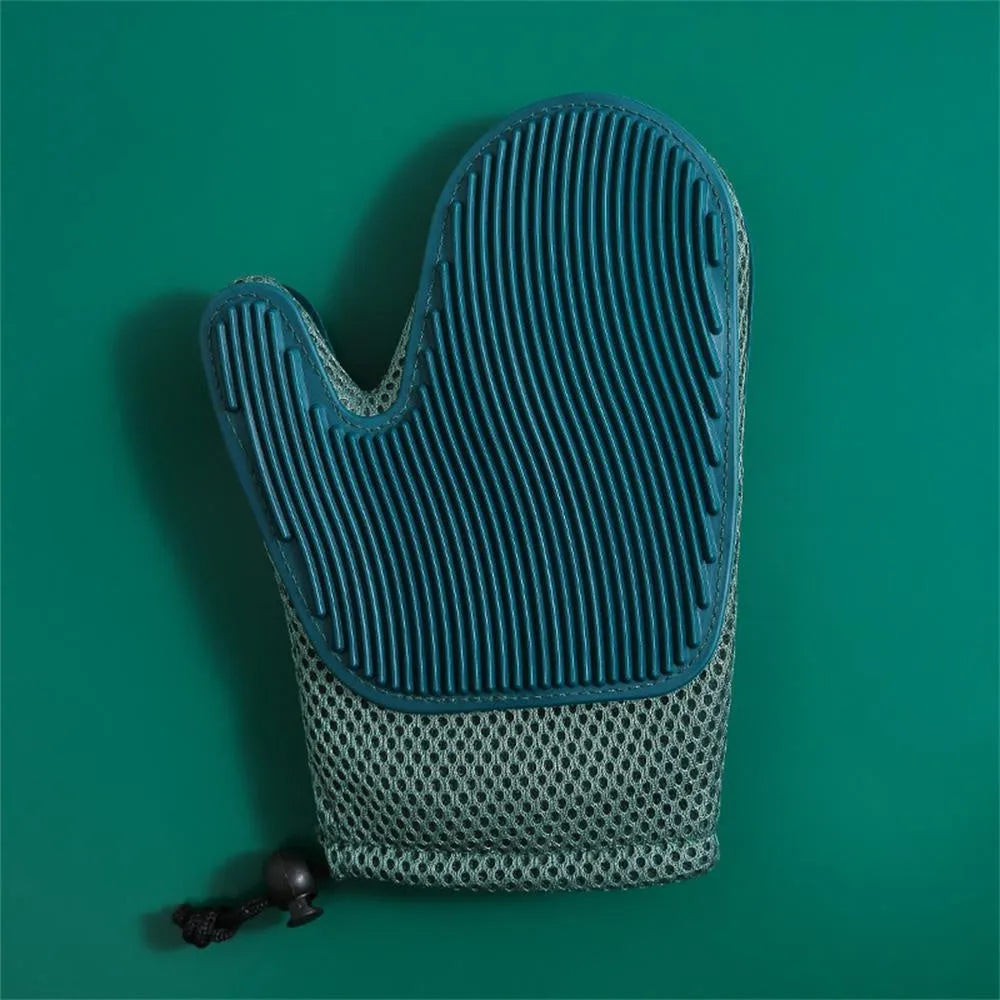 Right hand pet grooming glove in blue on fabric, showing mesh texture for removing cat and dog hair.