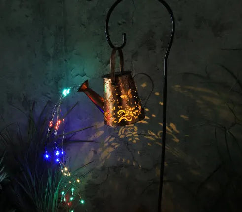 Tapered butterfly pattern iron solar garden lamp with warm white LED light.