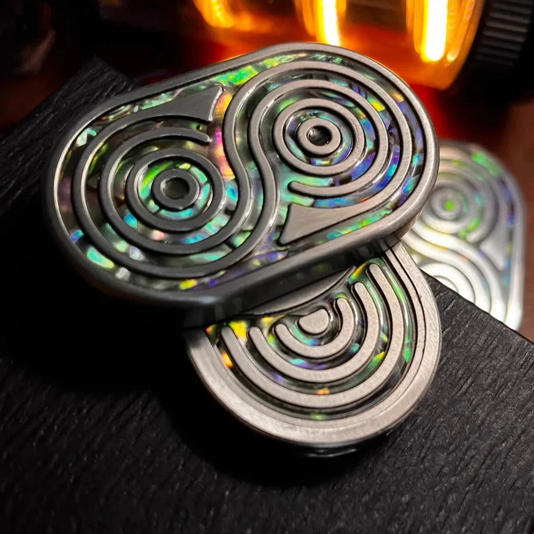 Stainless steel EDC hand push coin in agate red colour on plain background