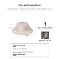 Beige wine bottle camping lantern with USB-C charging port and adjustable light modes on a wooden surface.
