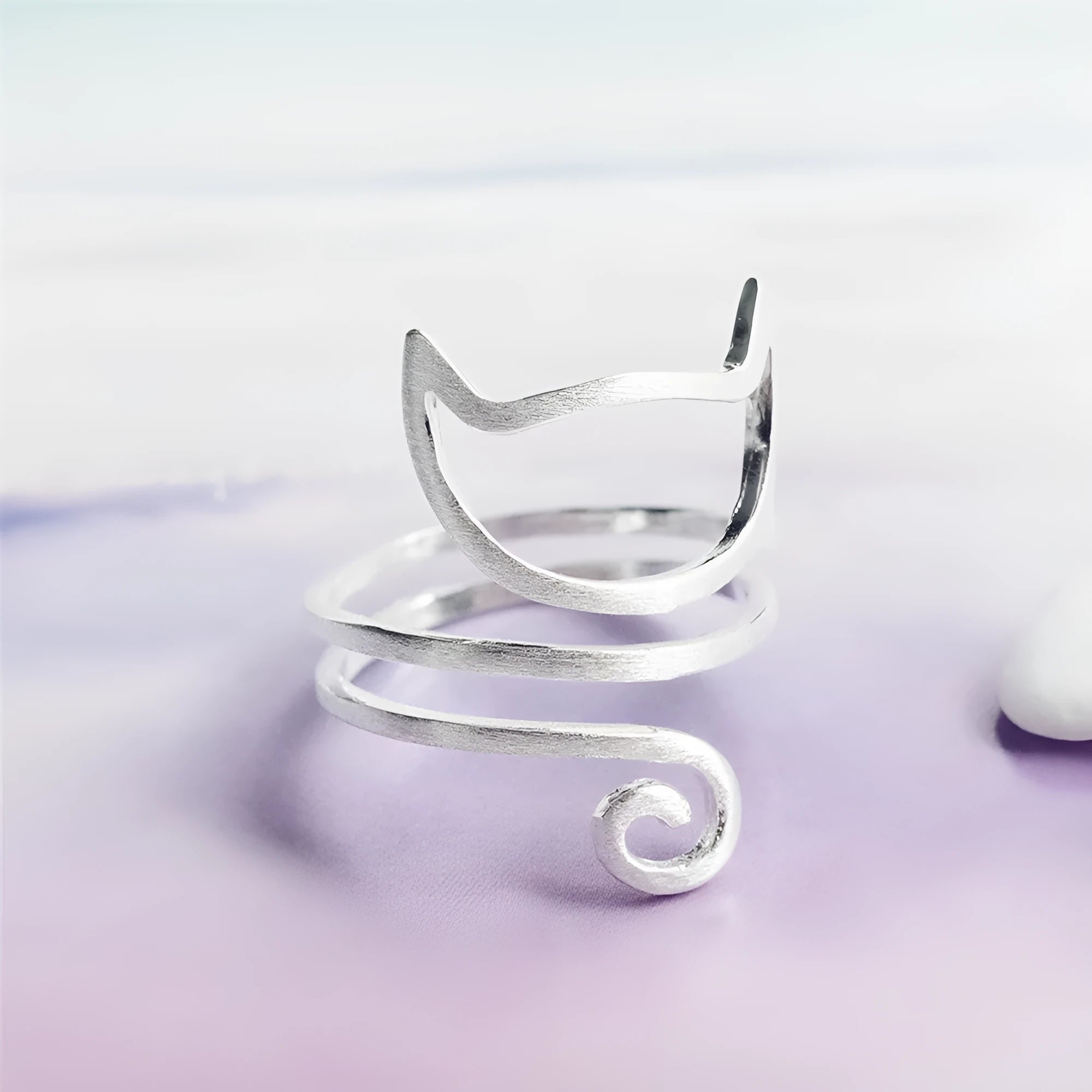 S925 silver adjustable cat ring with brushed winding design on a neutral background
