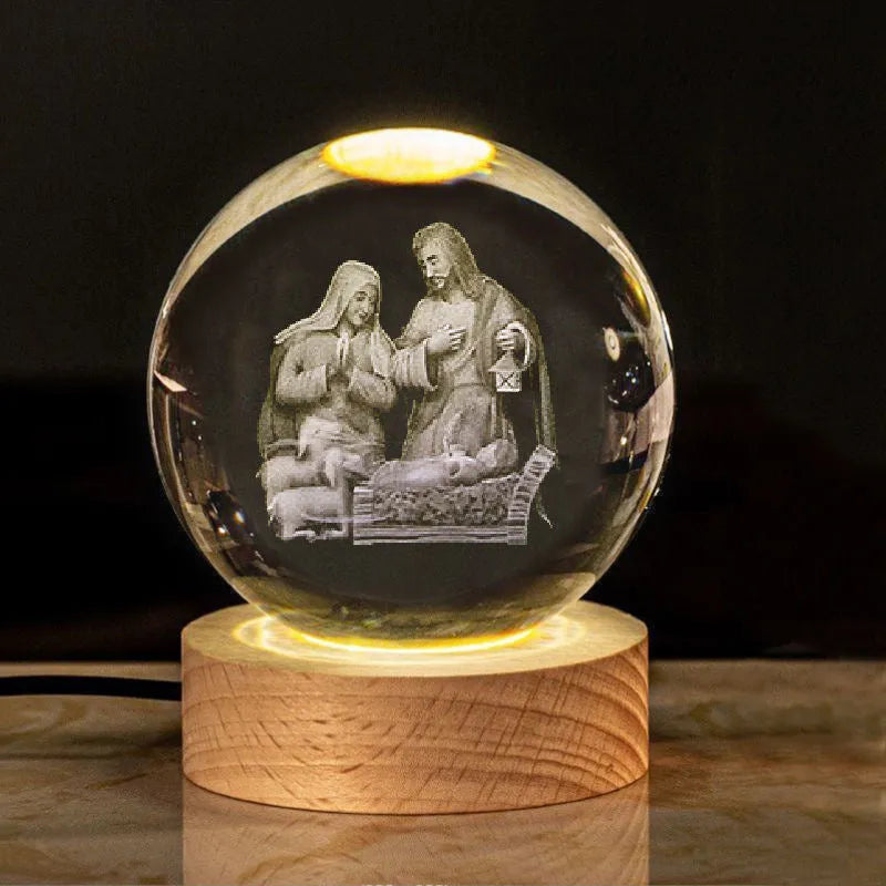 White crystal ball ornament on wood base with warm light and religious symbols
