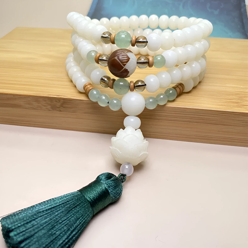 White jade bodhi 108-bead mala bracelet showing round beads in one of three pattern styles.