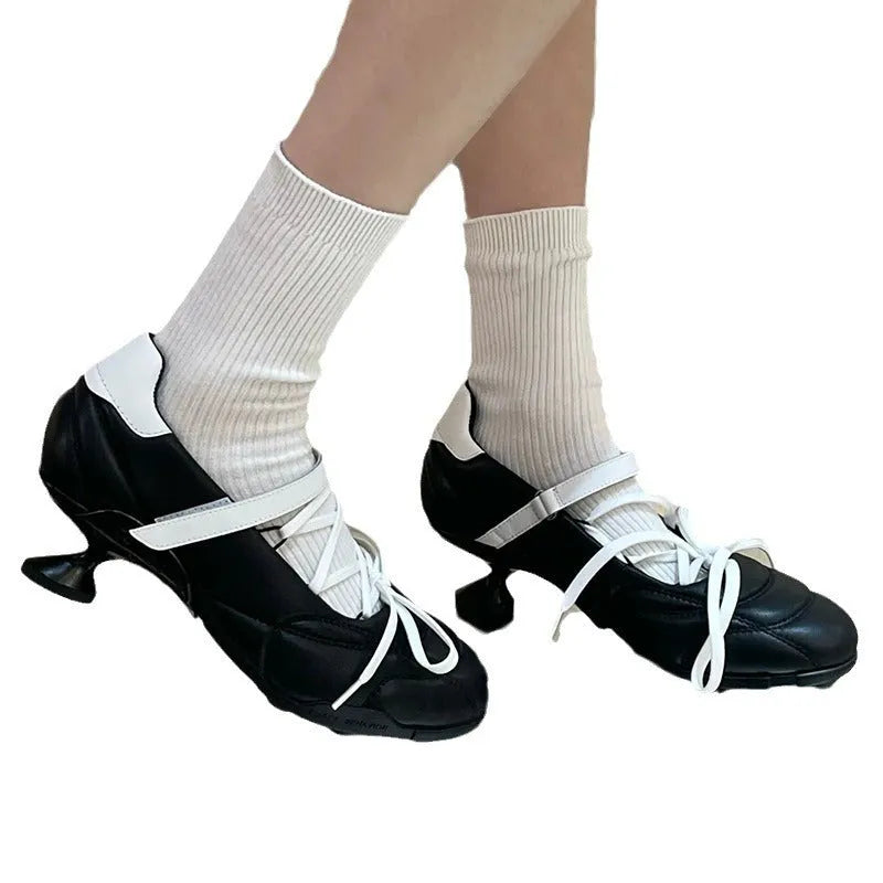 Women's silver lace-up sports shoes with a decorative bow on the front.