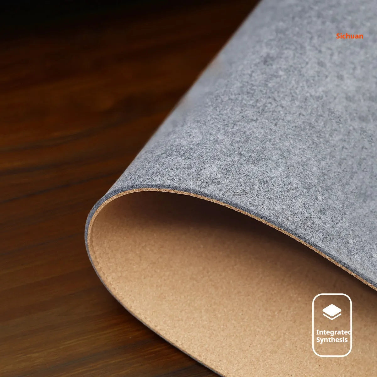 Oversized grey felt cork desk mat with minimalist design on a wooden desk