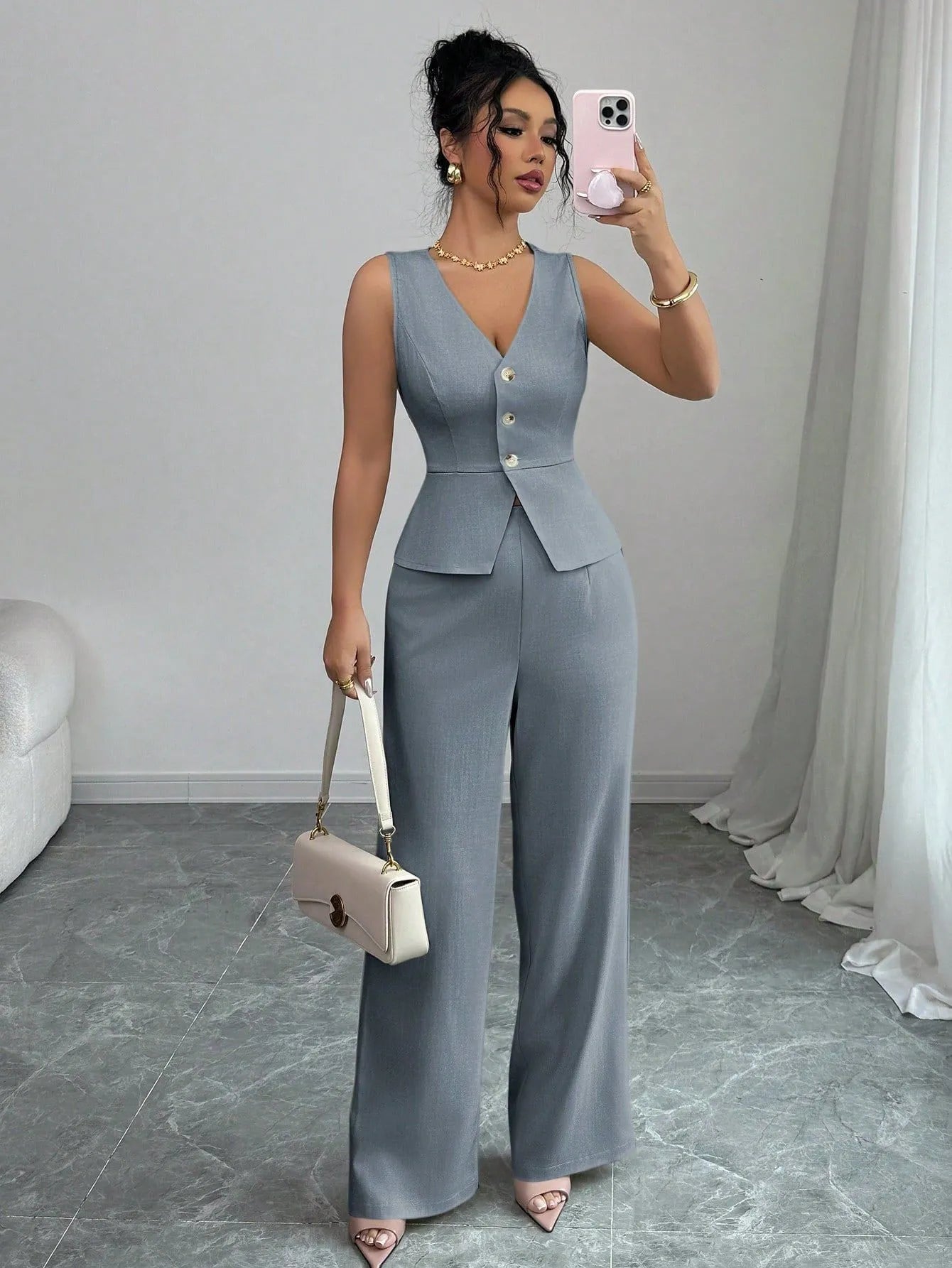 Women's solid colour sleeveless vest and high-waist trouser two-piece set in a casual style.