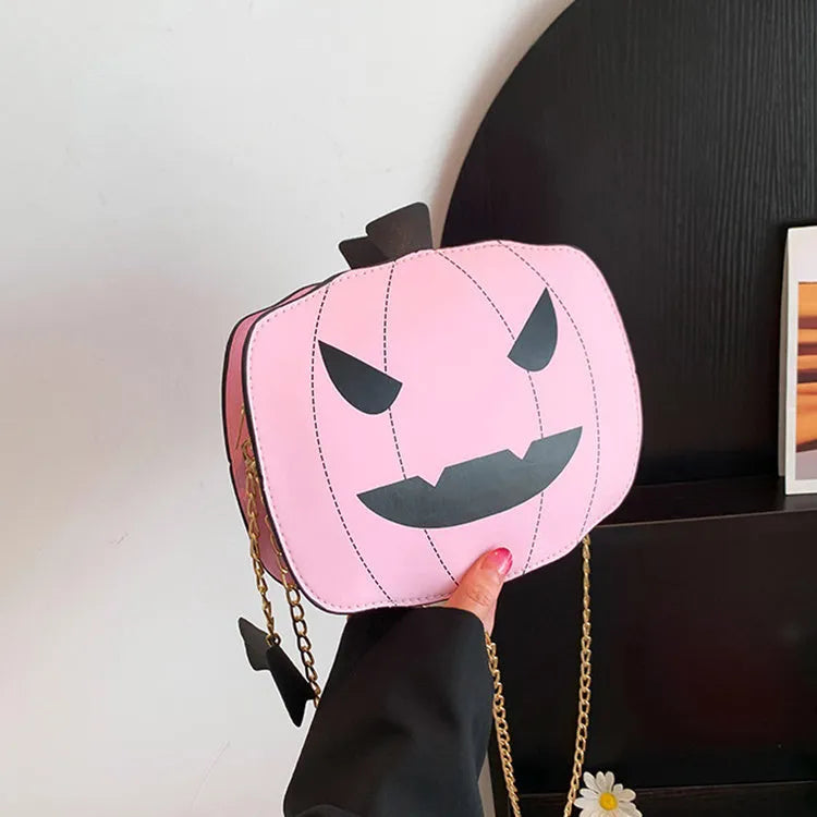 Cartoon pumpkin shoulder bag in orange with chain strap on white background