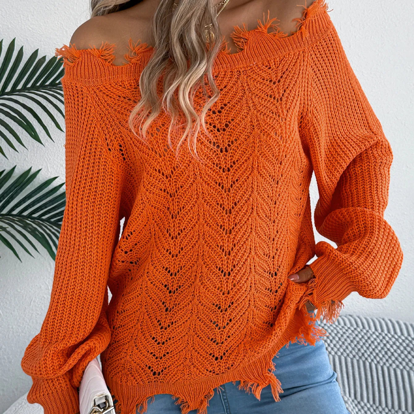Women's white hollow-out pullover sweater with cut off-the-shoulder design and long sleeves