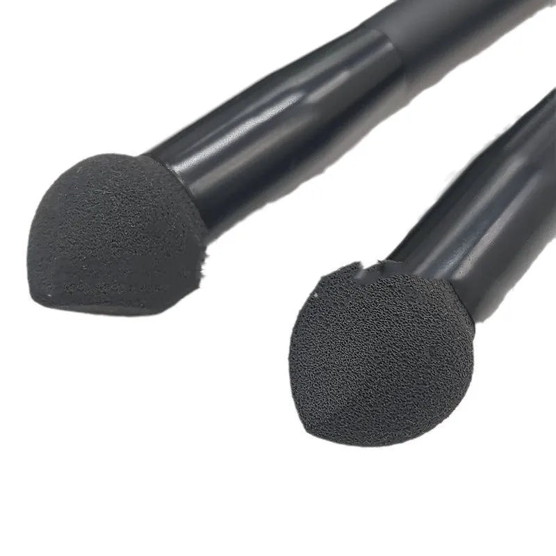 Black sponge tip concealer brush with a wooden handle for applying makeup to dark circles.
