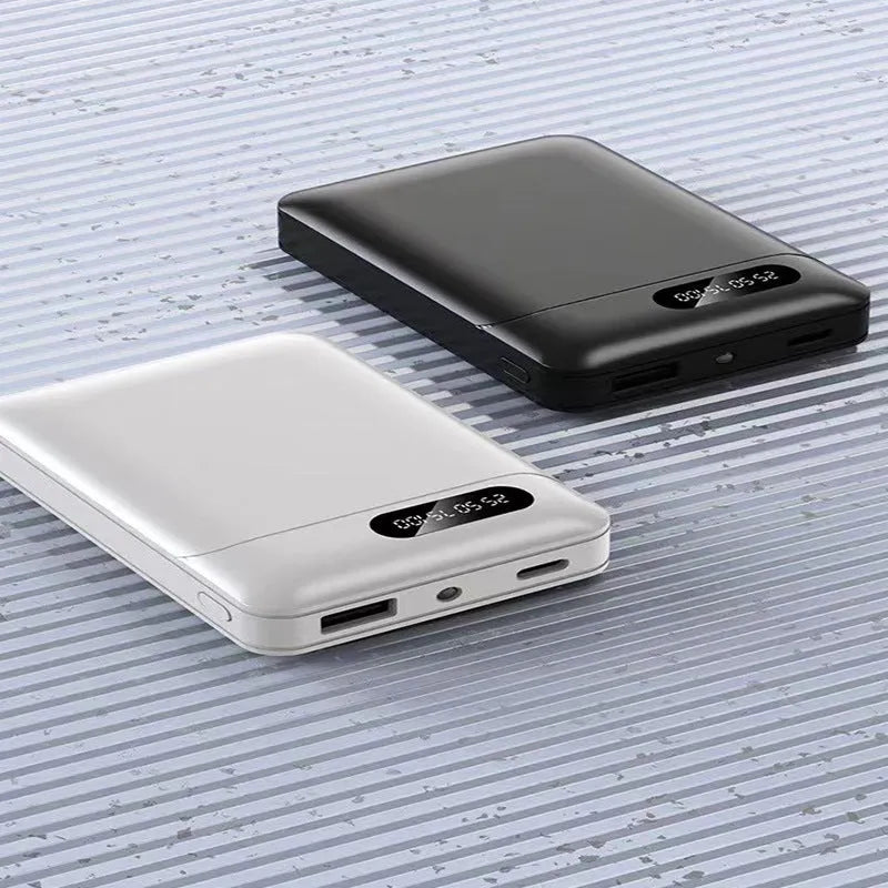 Black and white portable power bank showing dual USB ports and compact 92x63x23mm dimensions
