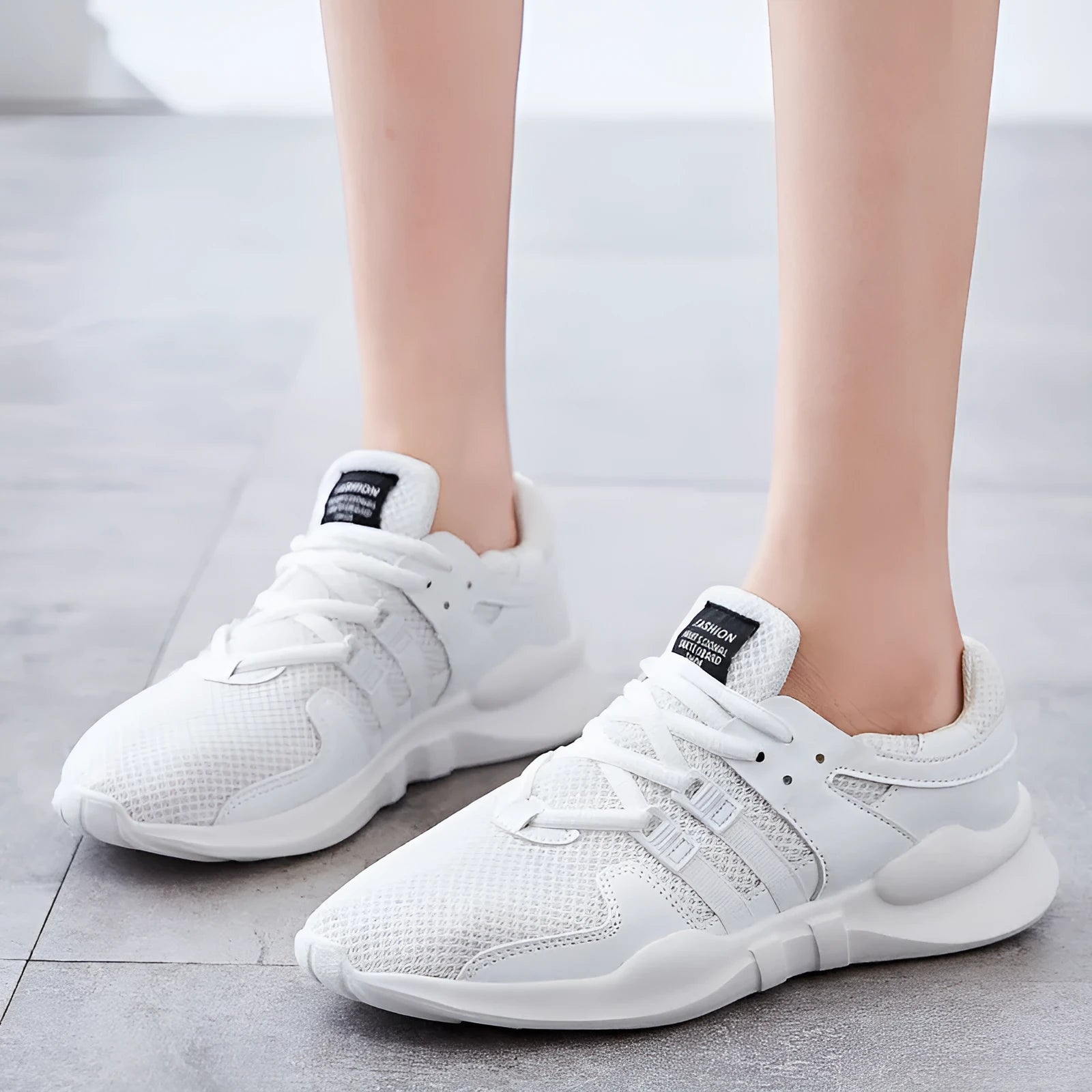 Low-top breathable mesh sneaker with hollow design in various colours on a white background.