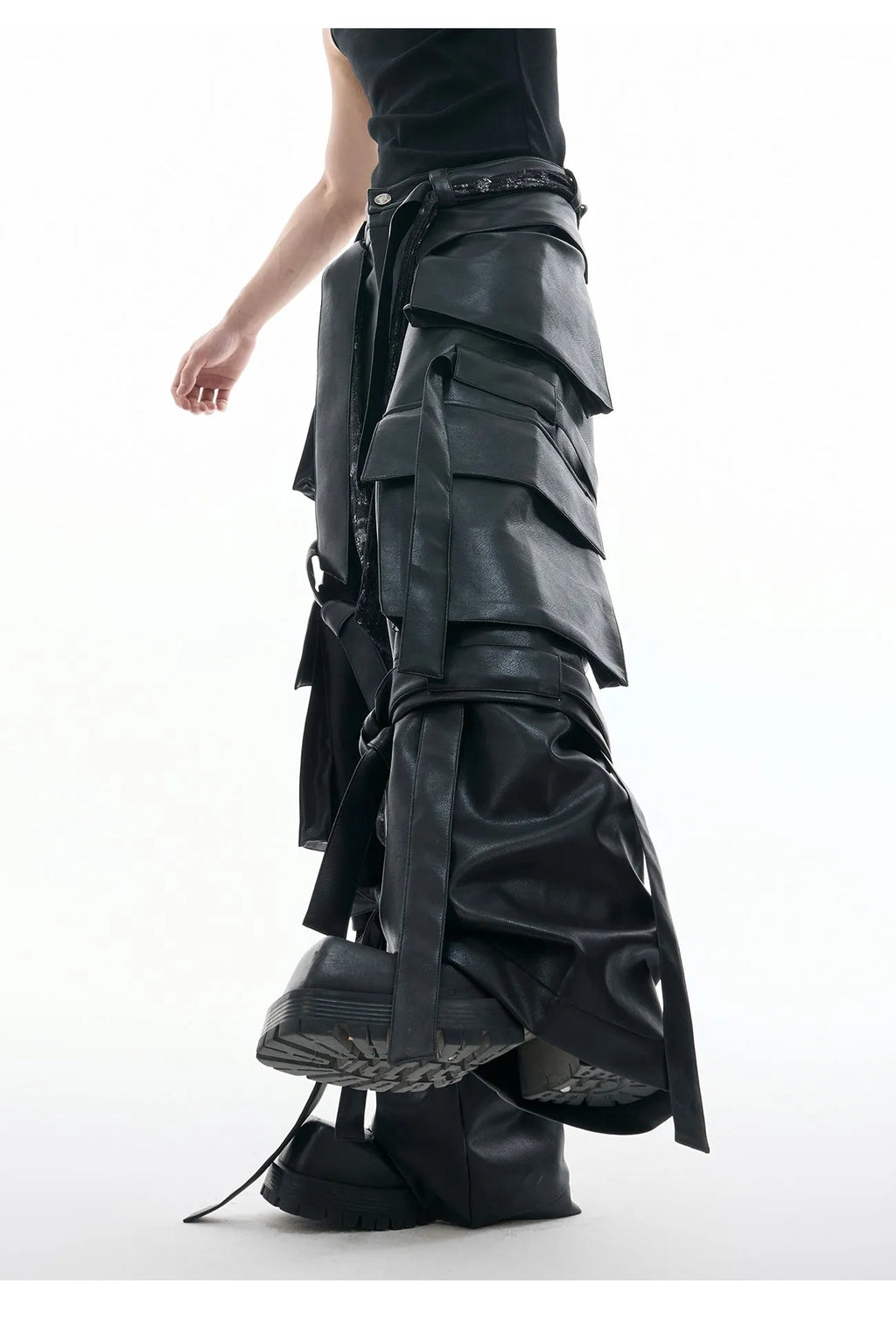 Black loose-fit men's trousers with multiple pockets, quilted panels, and decorative leather ribbon trim.