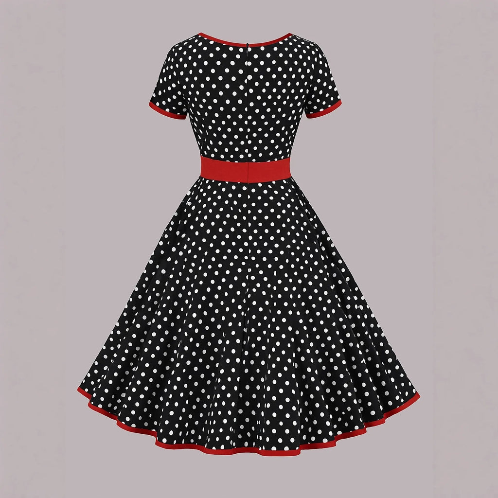 Women's multicolour polka dot pleated dress with square neckline, short sleeves, and front zip.