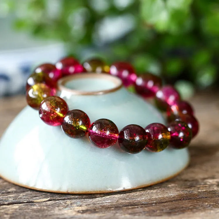 Handmade watermelon crystal bead bracelet with pastoral design elements on wrist