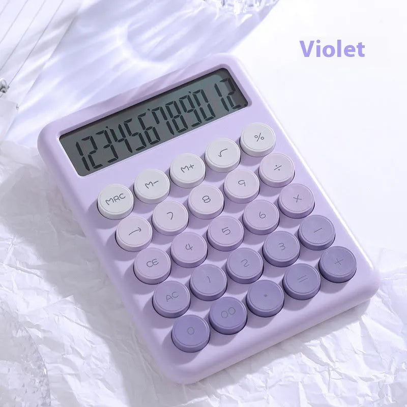 Desktop calculator with a gradient colour design in violet, blue, green, and pink tones on a white desk.