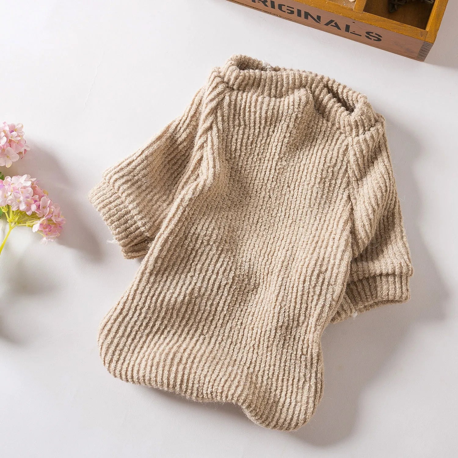 Brown cloth pullover sweater for small breed dog on model showing size fit