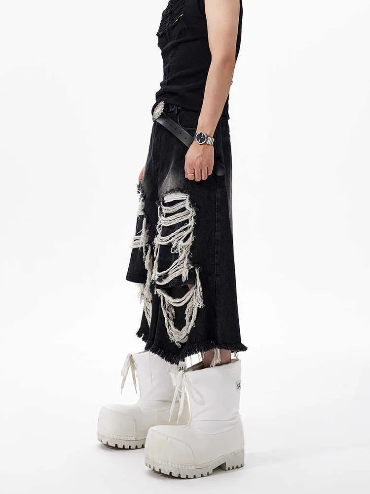 Black women's wide-leg cropped jeans with ripped patch details on the legs.