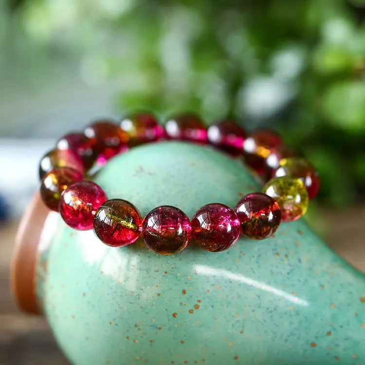 Handmade watermelon crystal bead bracelet with pastoral design elements on wrist
