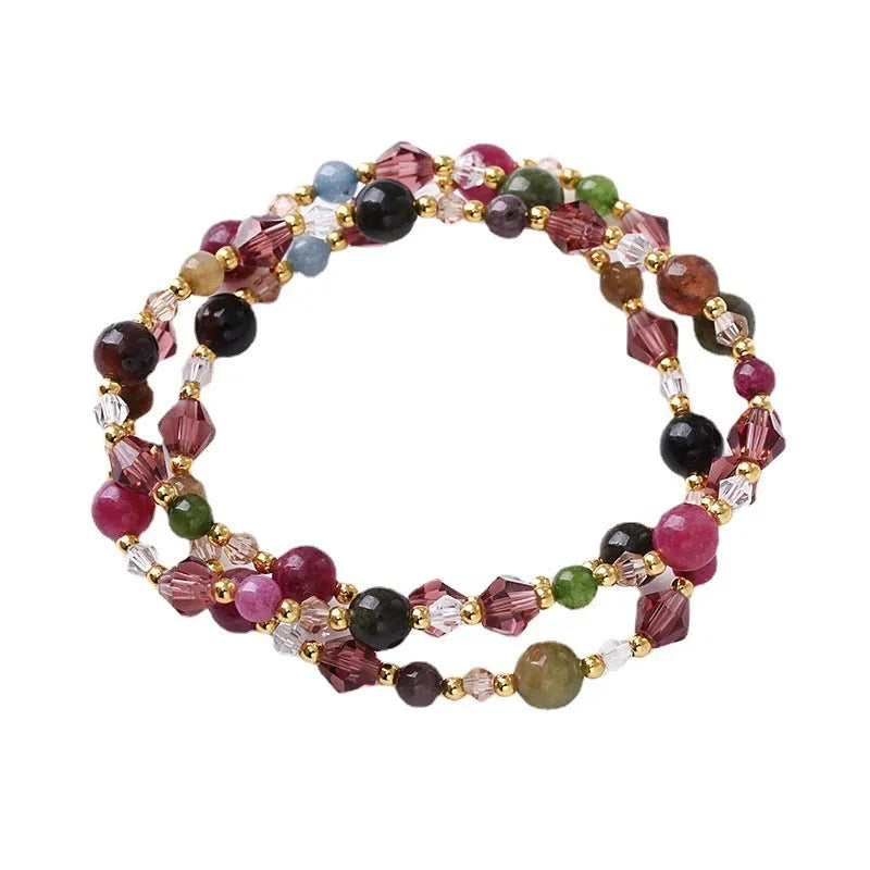 Colourful three-ring crystal bracelet with tourmaline, strawberry quartz, and amethyst beads on an adjustable cord.