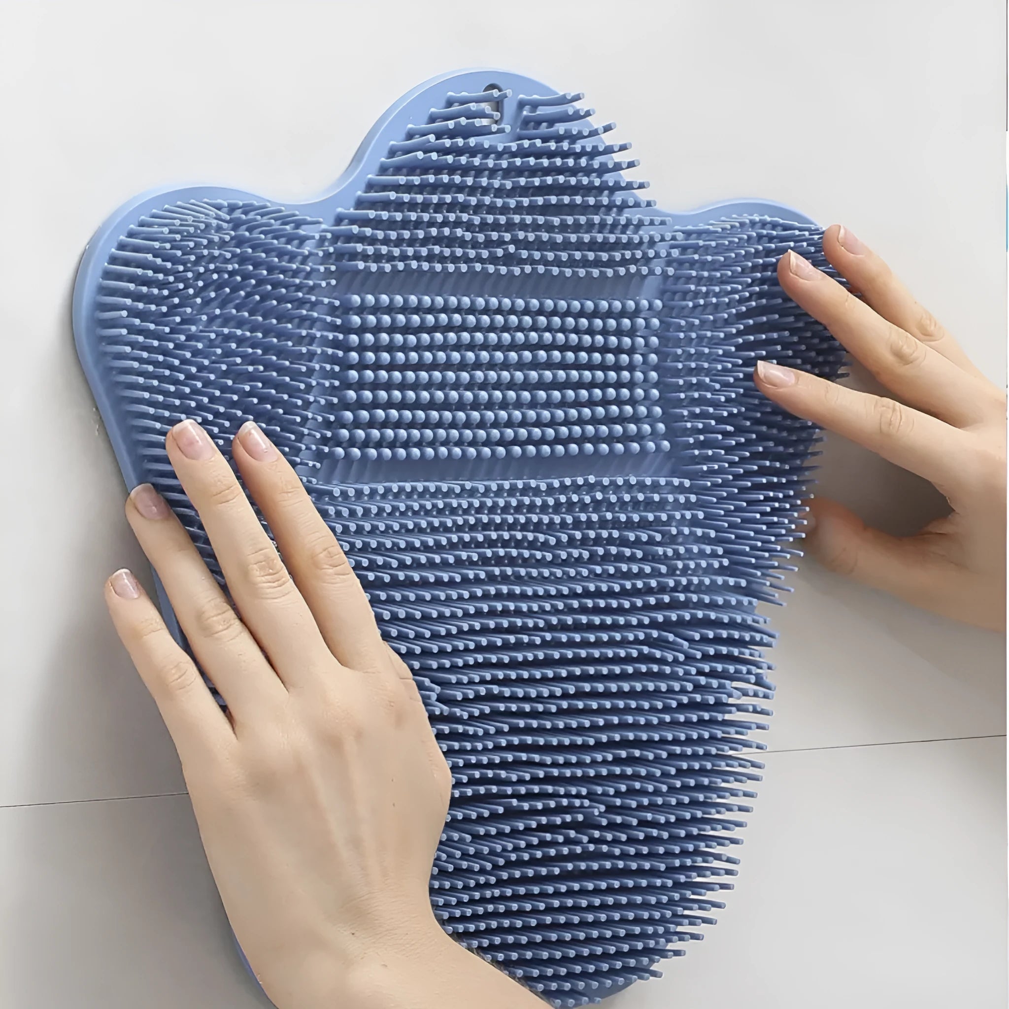 Blue silicone bath rub cushion mat for back scrubbing, shown flat with textured surface.