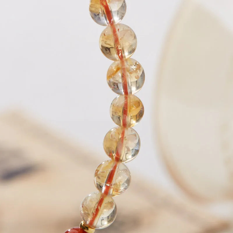 Hand-woven citrine crystal bracelet with five-sutra geometric pattern showing 6mm bead size