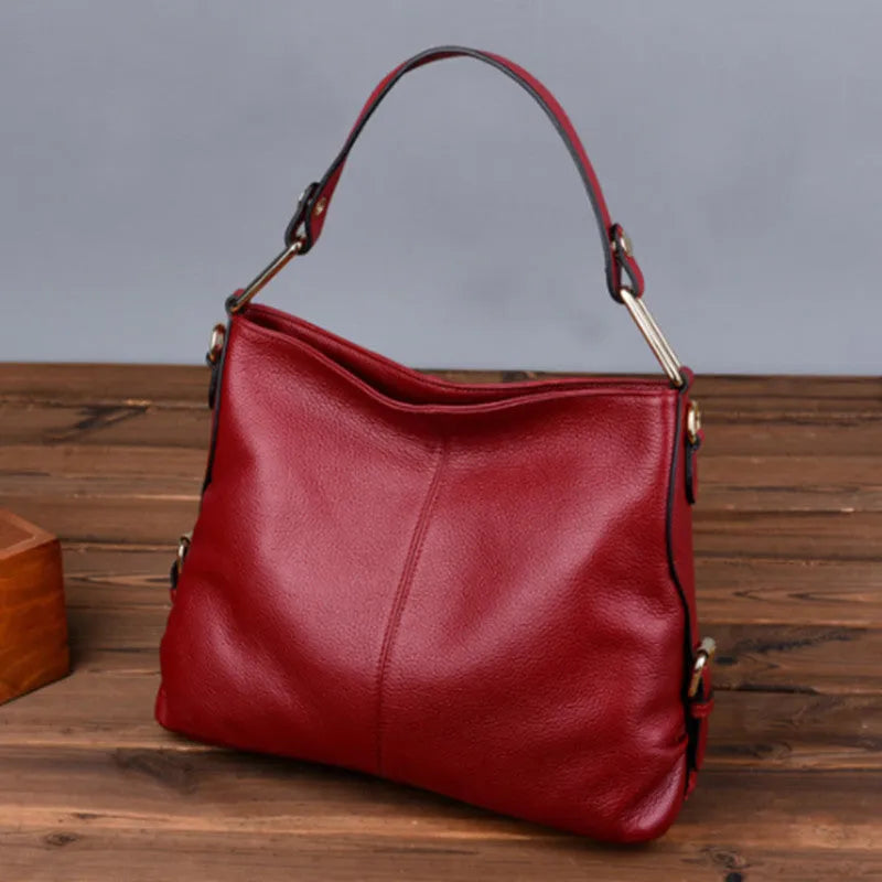 Genuine leather crossbody bag showing vertical square shape and internal compartments for phone and documents