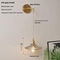 Retro brass lotus wall lamp with a glass shade in a choice of six colours.