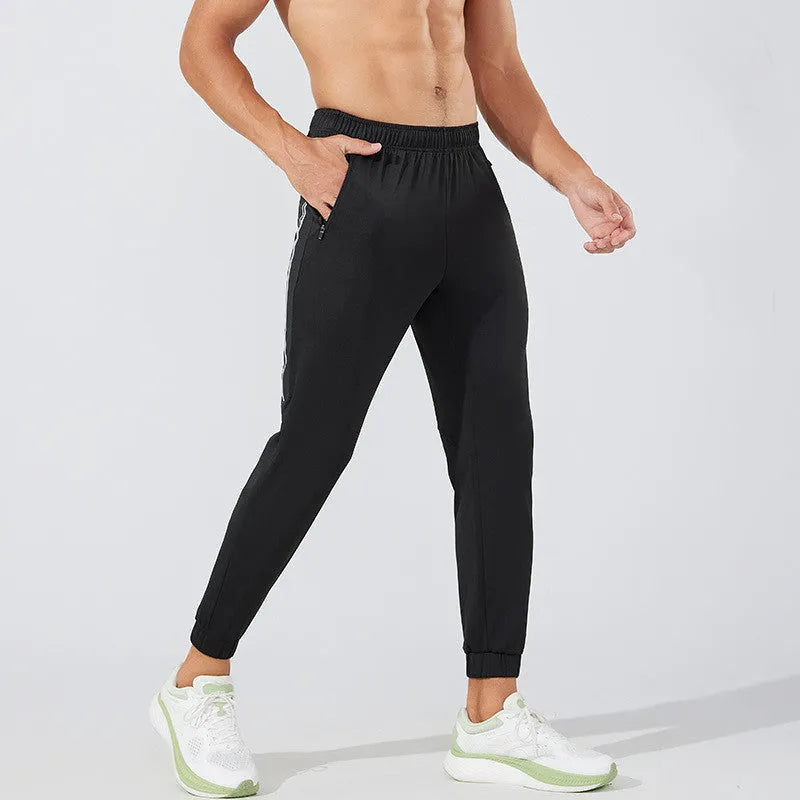 Men's black running trousers with mid-waist design and full-length cut for exercise activities