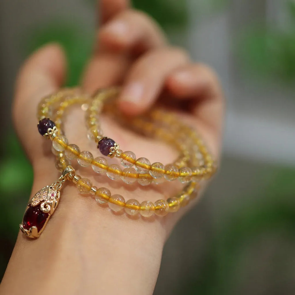 Handmade gold rutilated quartz bracelet with Chinese style hanging chopsticks and ruby quartz charm