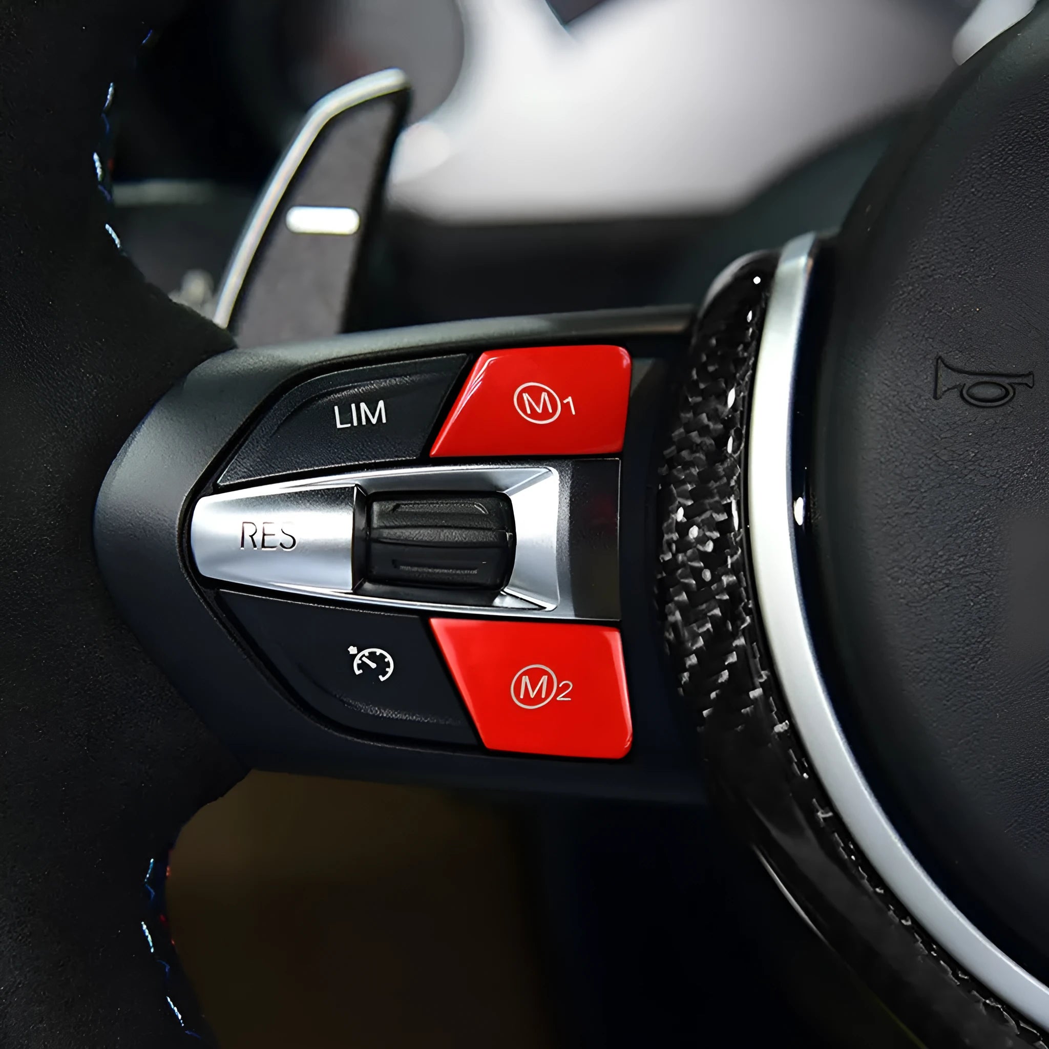 Red and blue BMW M1 M2 steering wheel button accessories with installation keys on a black background