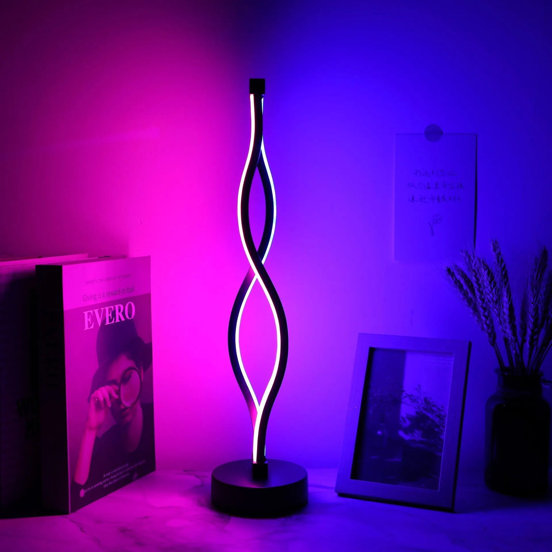 Black aluminium desk lamp with a dimming button and touch controls for blue and pink light